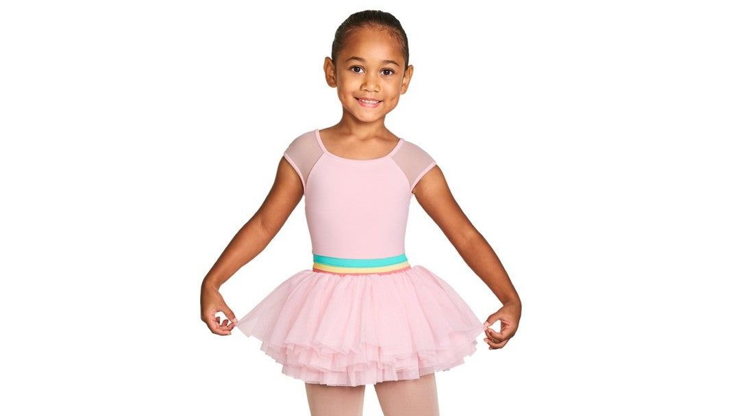 A young ballet dancer wearing the Mabel Mabel cap sleeve tutu leotard in candy pink