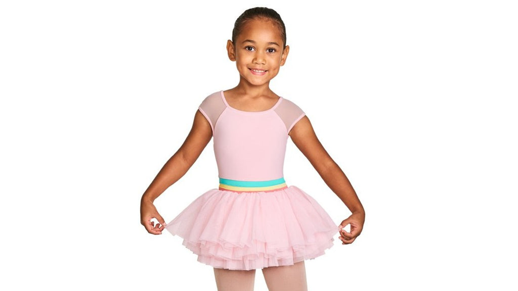 A young ballet dancer wearing the Mabel Mabel cap sleeve tutu leotard in candy pink