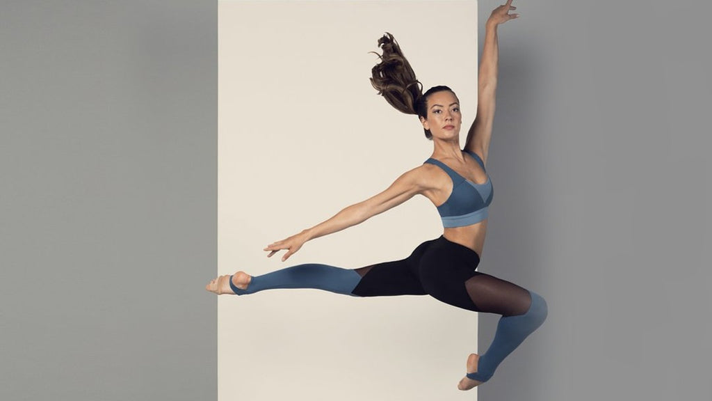 Ballet dancer Tierney Heap leaping through the air wearing Colour bloch separates leggings and crop top